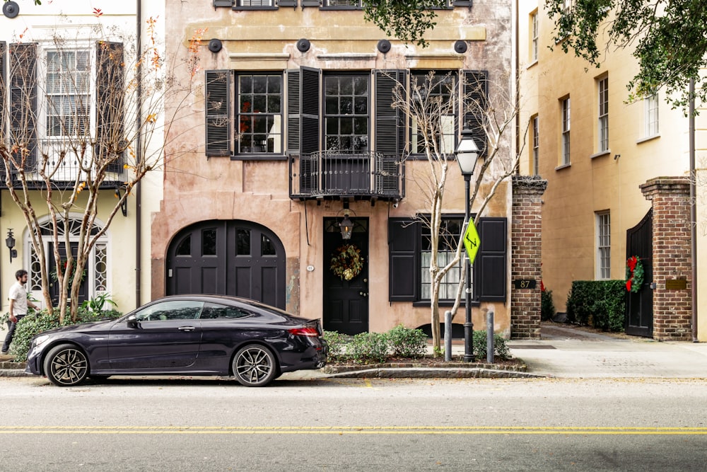 a black car parked in front of a building