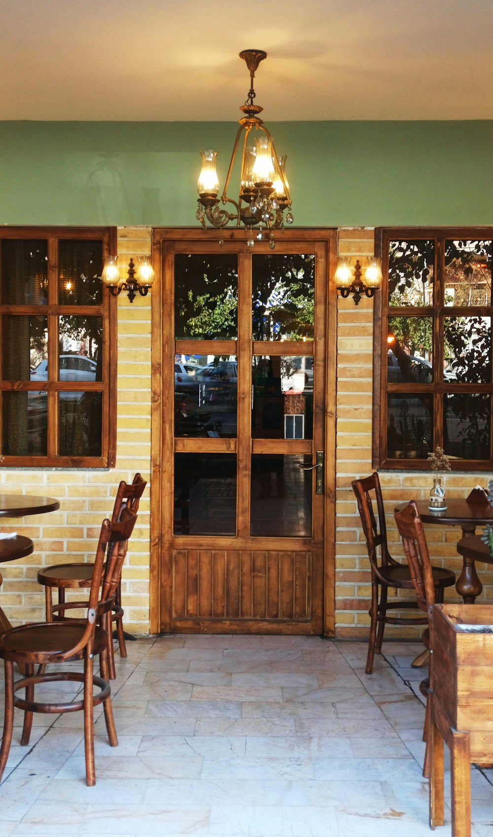 a restaurant with tables and chairs and a chandelier