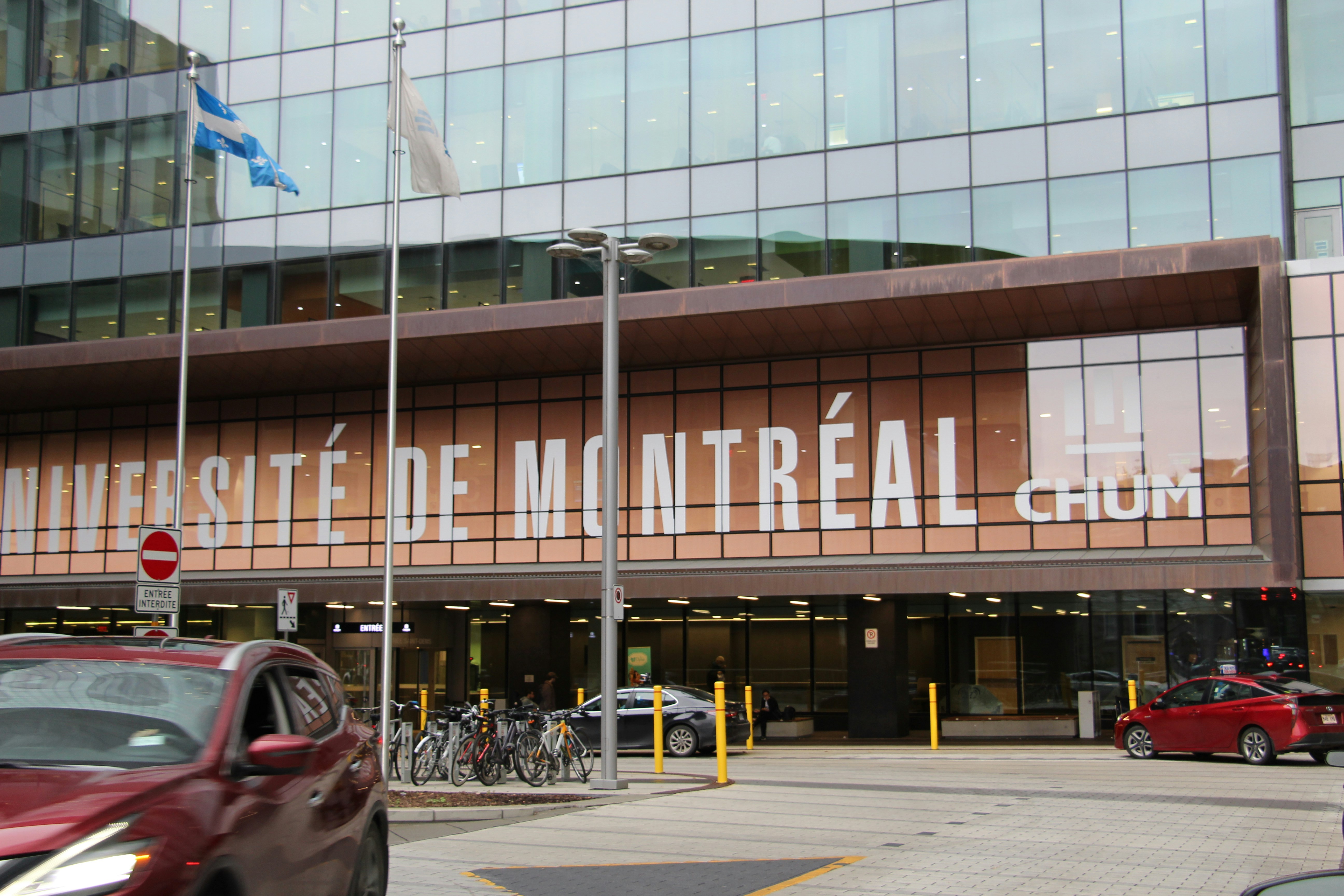 A red car in front of a building, symbolizing potential alternatives during transit disruptions.