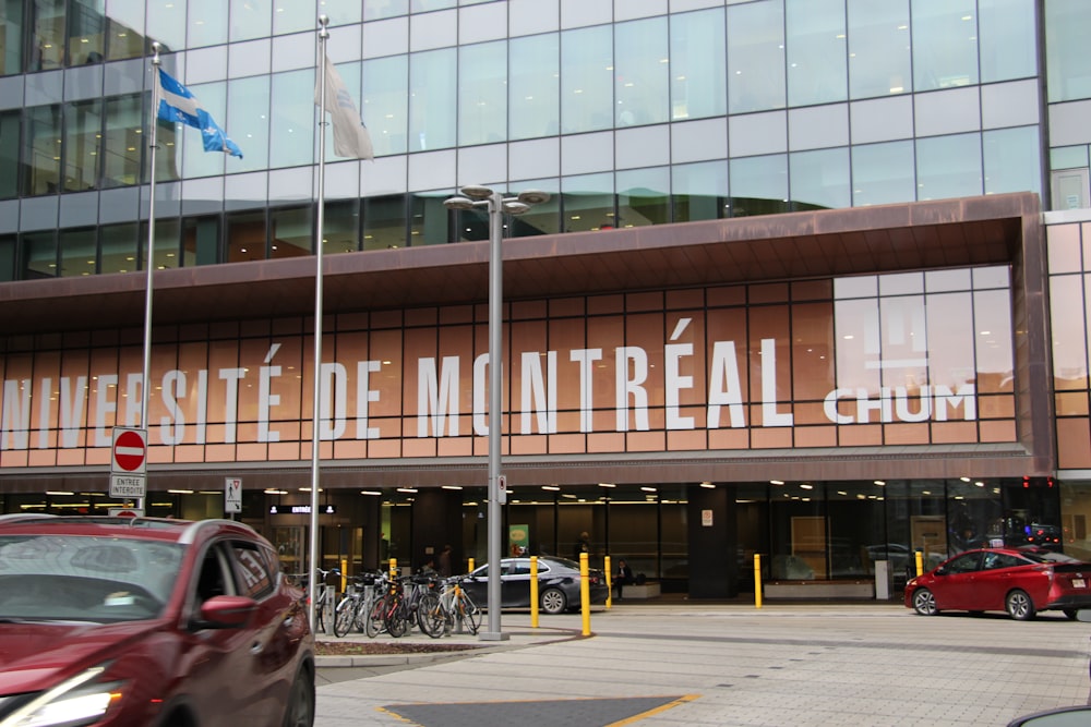 a red car is parked in front of a building