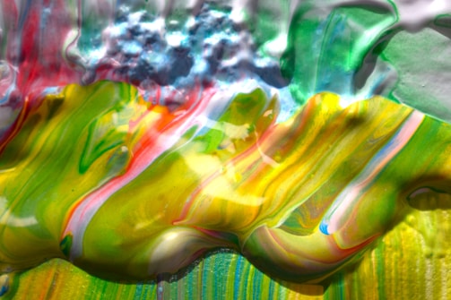 A vibrant painting of swirling colors blending into a serene landscape.