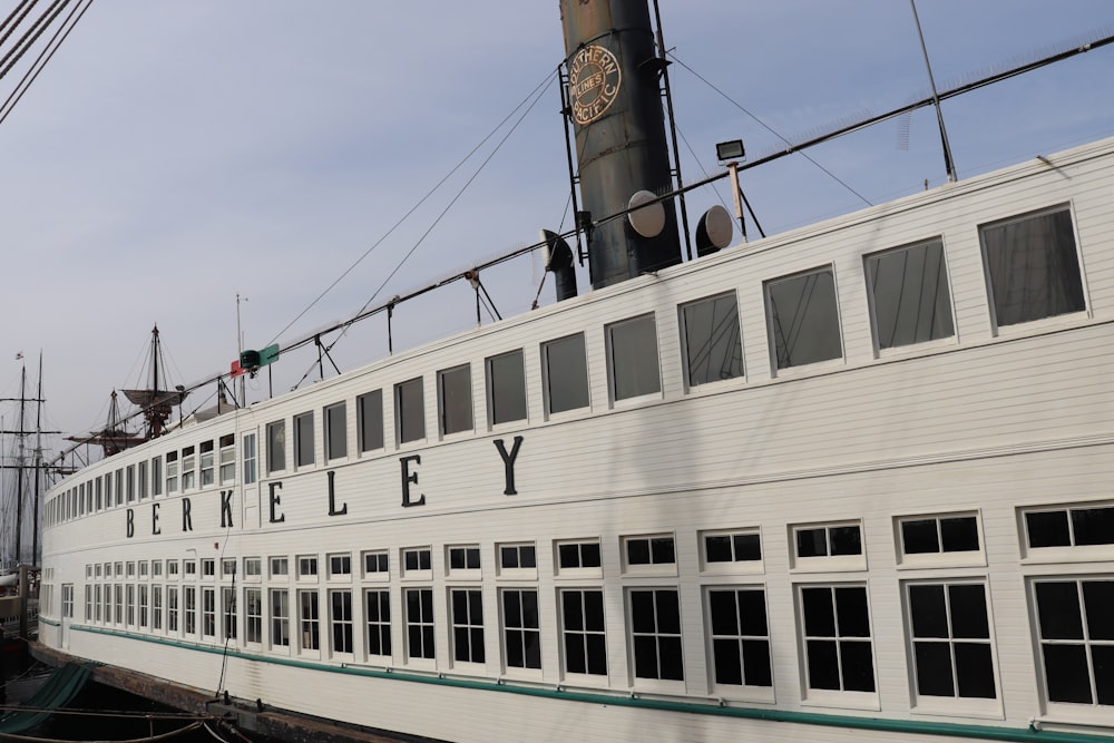 a large white boat with a clock on the side of it