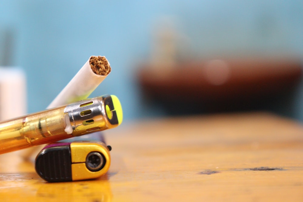 a close up of a cigarette and a lighter on a table