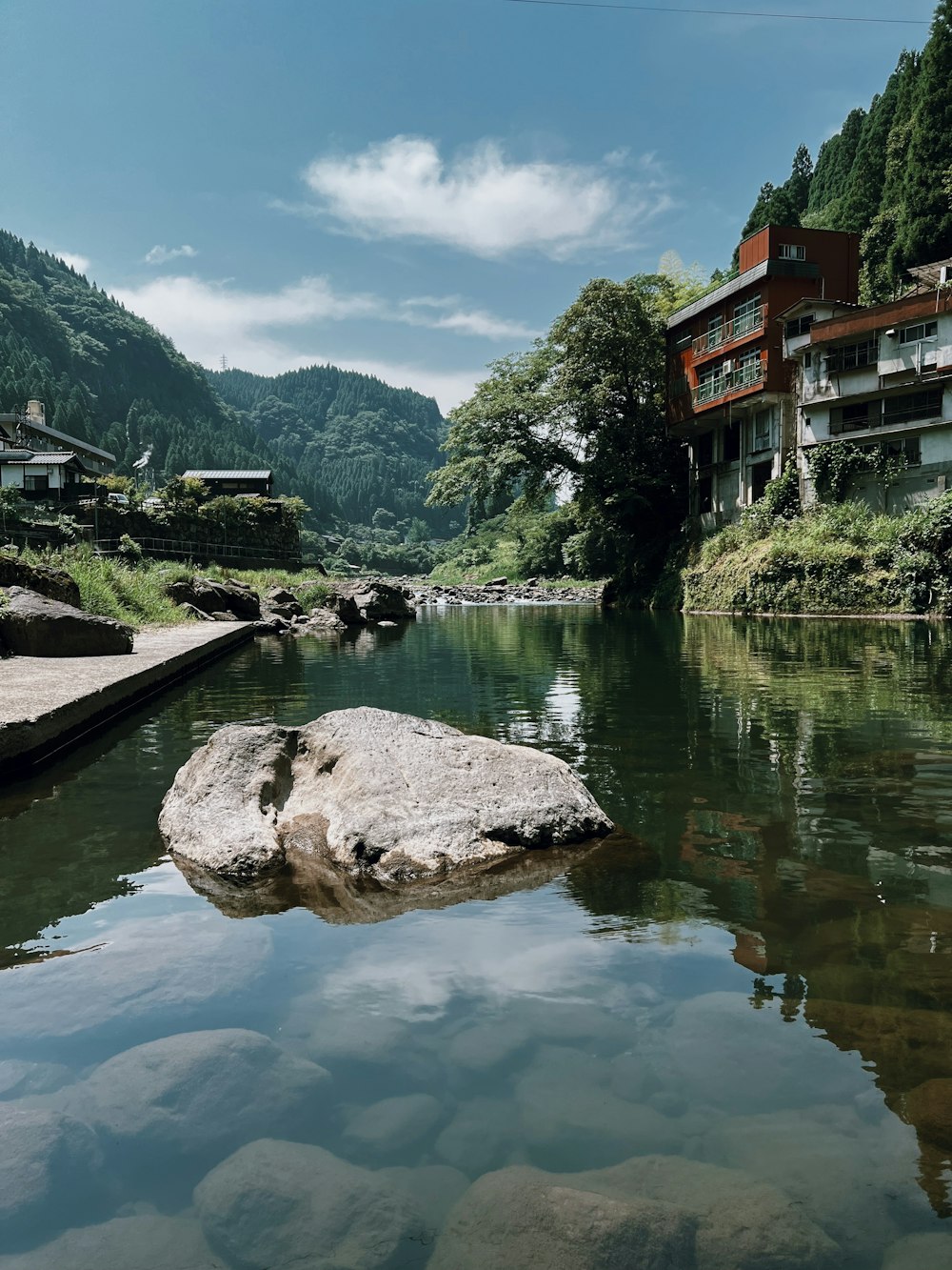 a body of water with a rock in the middle of it