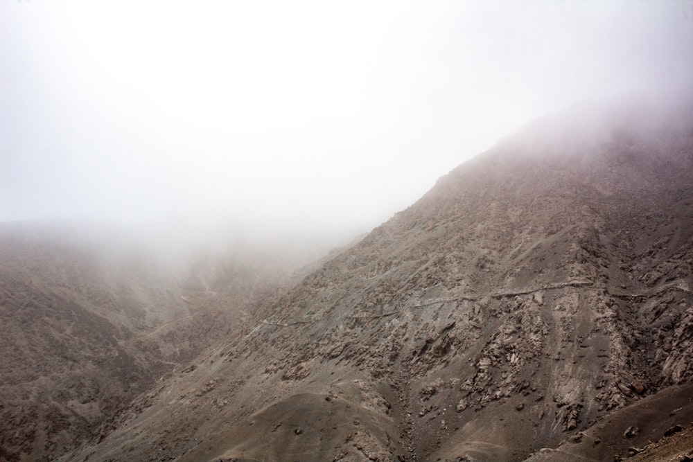 a mountain covered in fog and low lying clouds