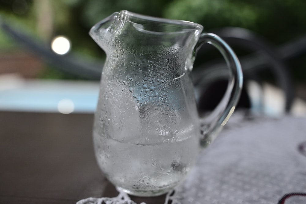 a pitcher of water sitting on top of a table