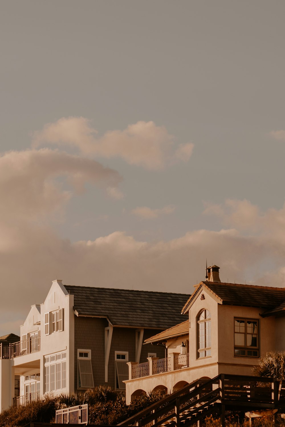 a row of houses sitting on top of a lush green hillside