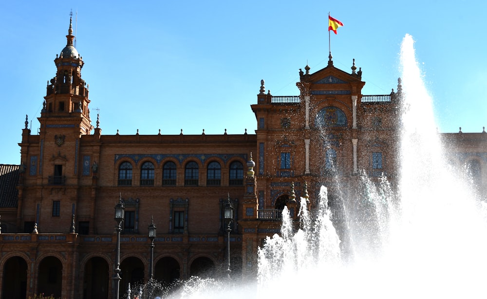 a large building with a fountain in front of it