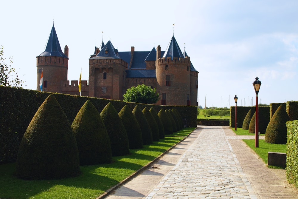 a brick walkway leading to a castle like building