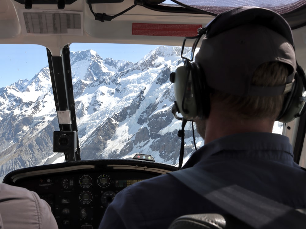 a couple of men sitting in the cockpit of a plane