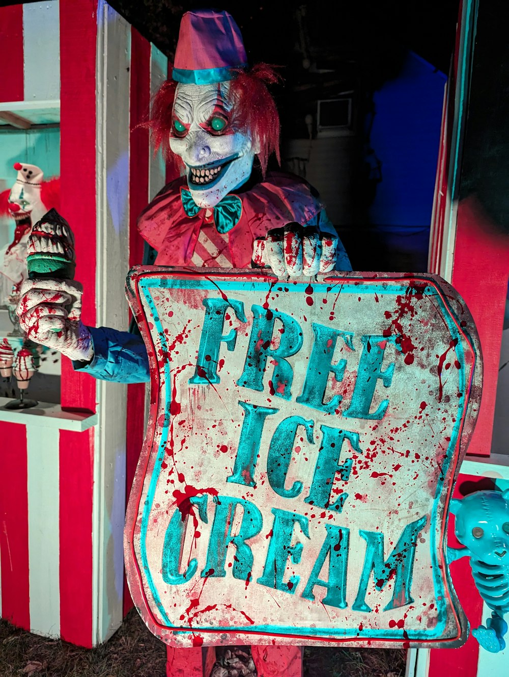 a creepy clown holding a free ice cream sign