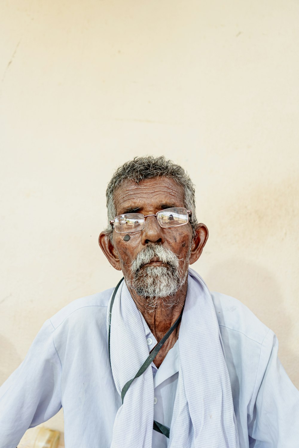 an old man with glasses and a tie