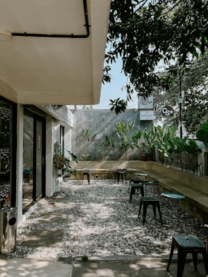 An outdoor seating area with simple furniture.