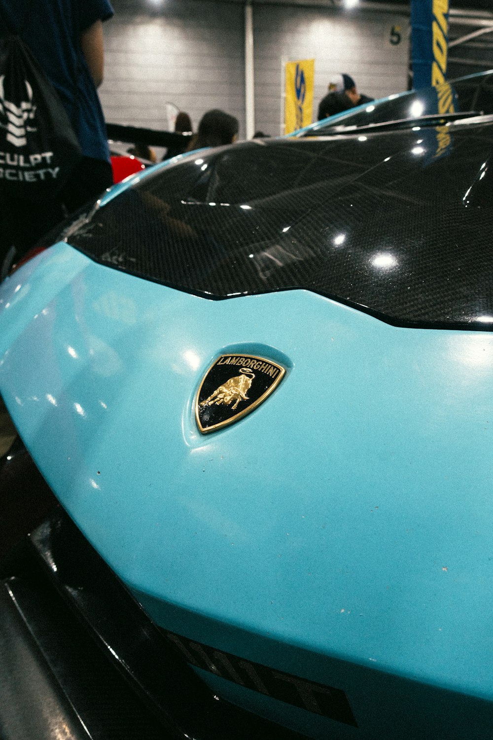 a close up of the hood of a blue sports car