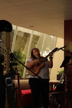 A small group of students happily playing ukuleles together during a lively lesson.