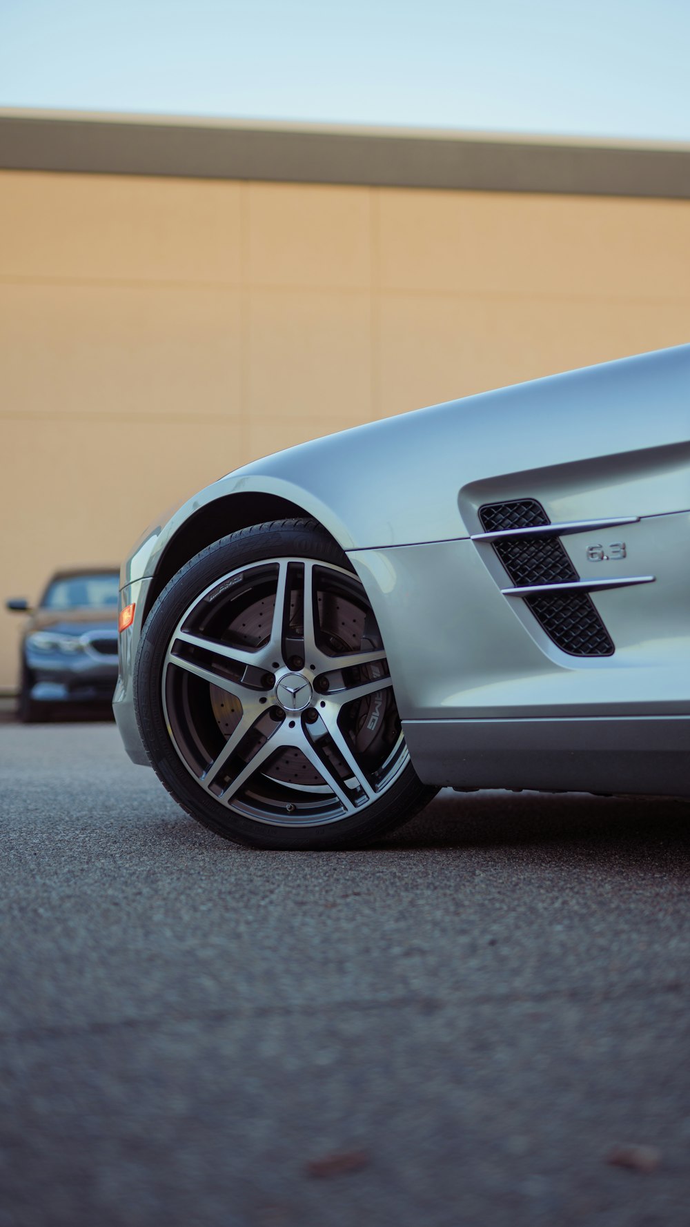 a silver sports car parked in front of a building