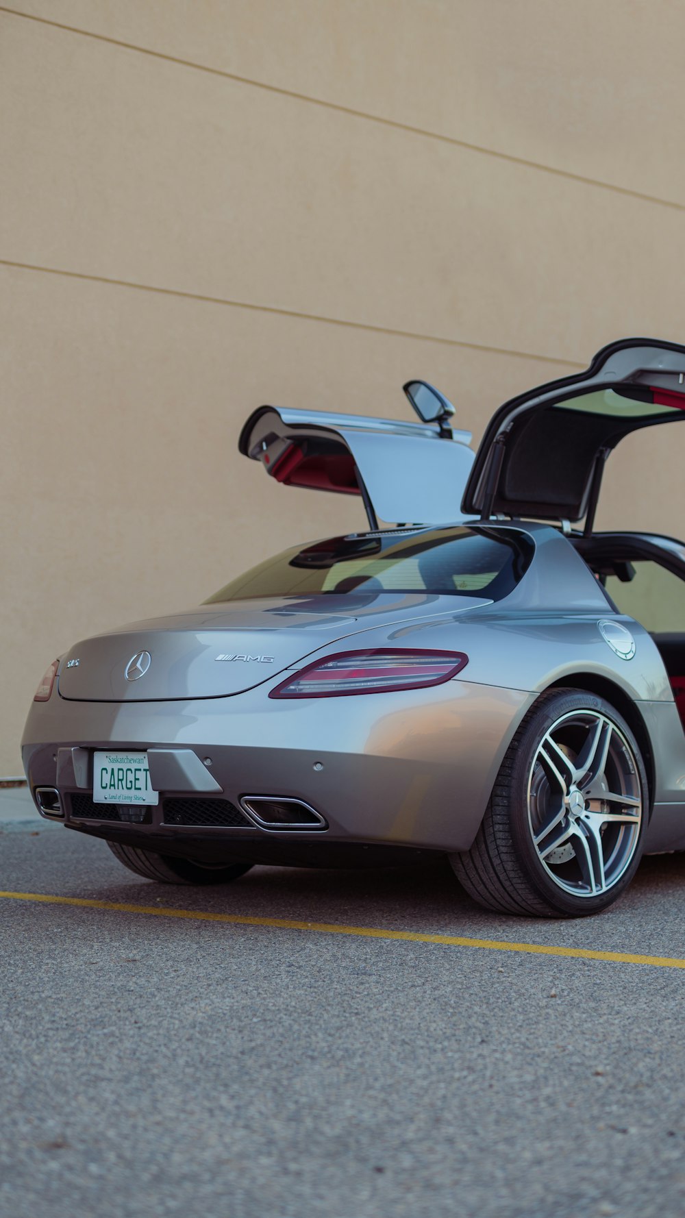 a silver sports car parked in front of a building