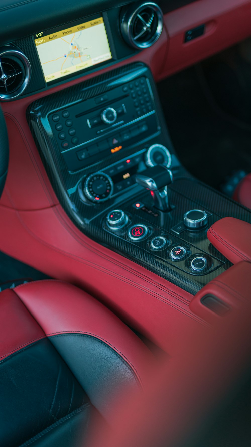 the interior of a sports car with red leather