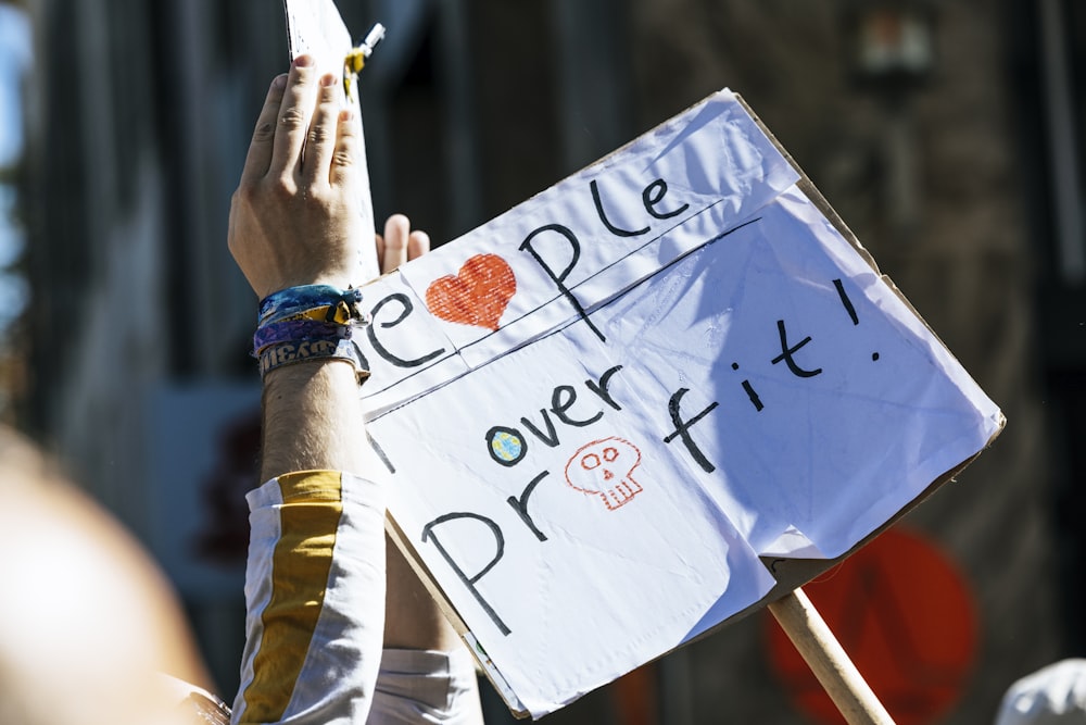 a person holding a sign that says people power it