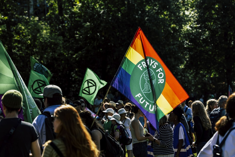 a group of people holding a rainbow flag