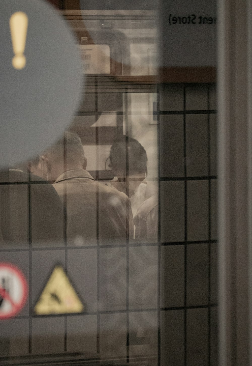 a reflection of a man and a woman in a window