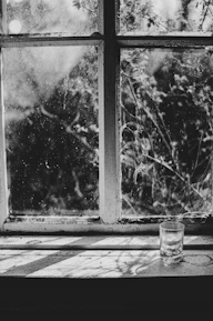 Before-and-after shot showing a window frame covered in dirt and then sparkling clean.