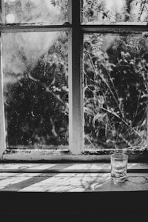 Before and after shots of a grimy window transformed to spotless clarity.