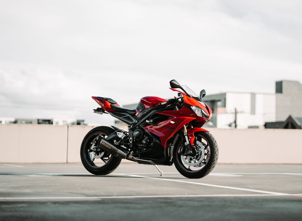 a red motorcycle parked in a parking lot