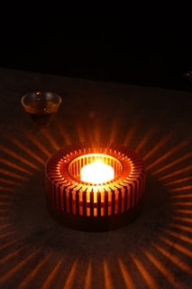 a lit candle sitting on top of a table