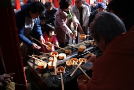 Volunteers and Jogini community members gathered around a new clean water fountain project.