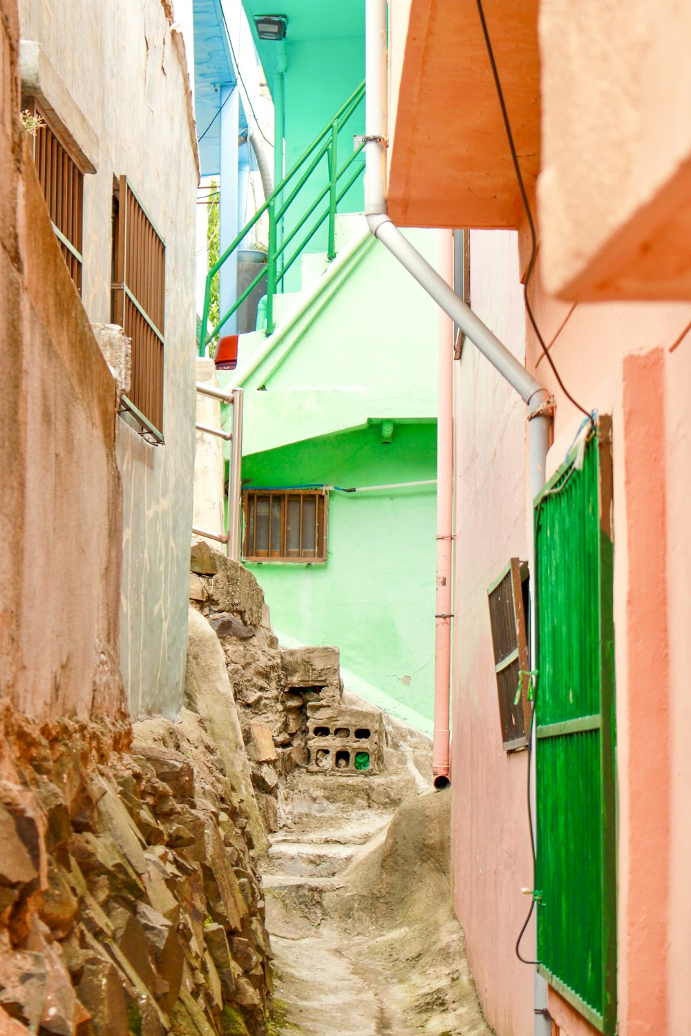 a narrow alley way with a green door