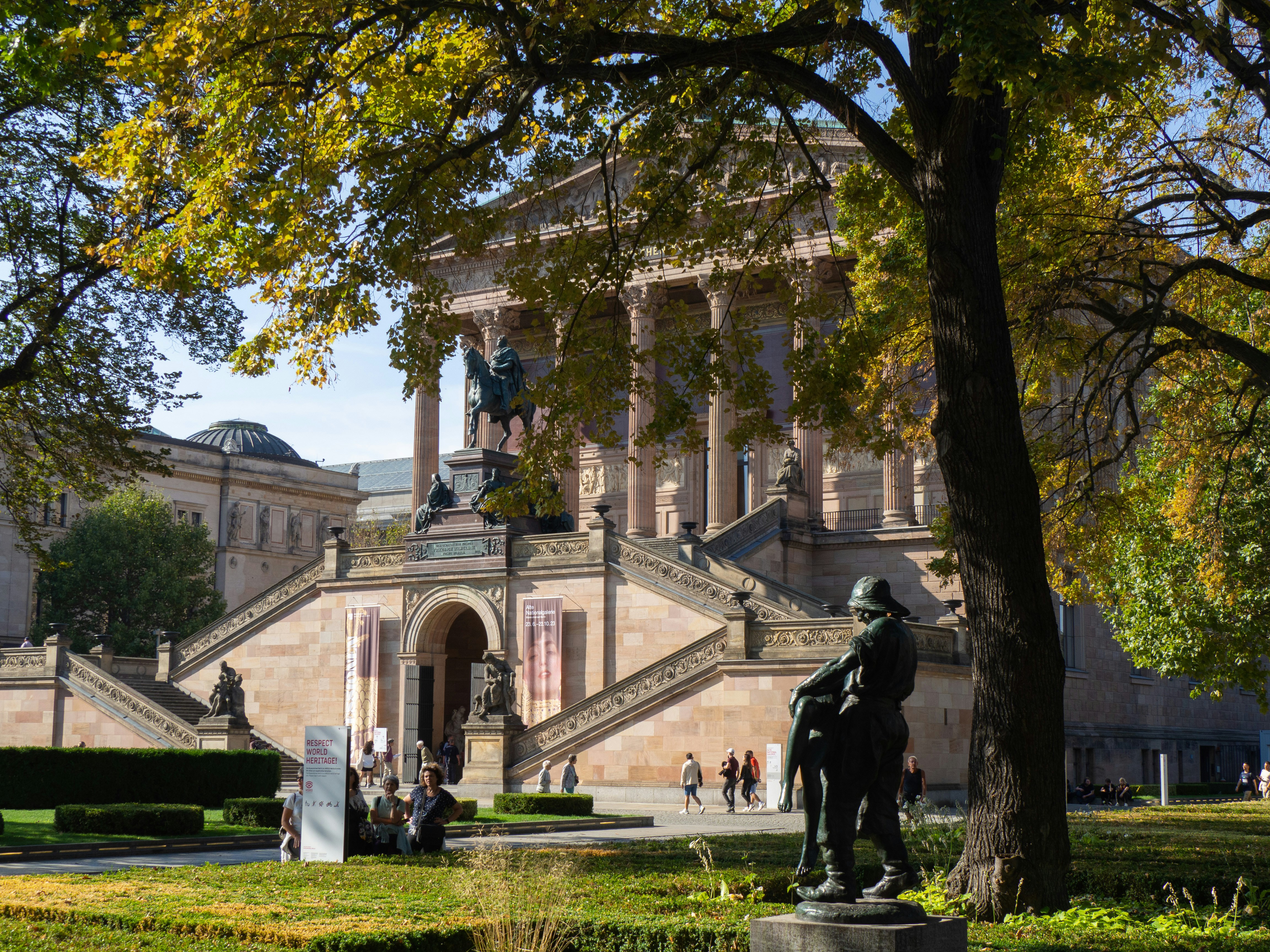a statue of a man on a horse in front of a building