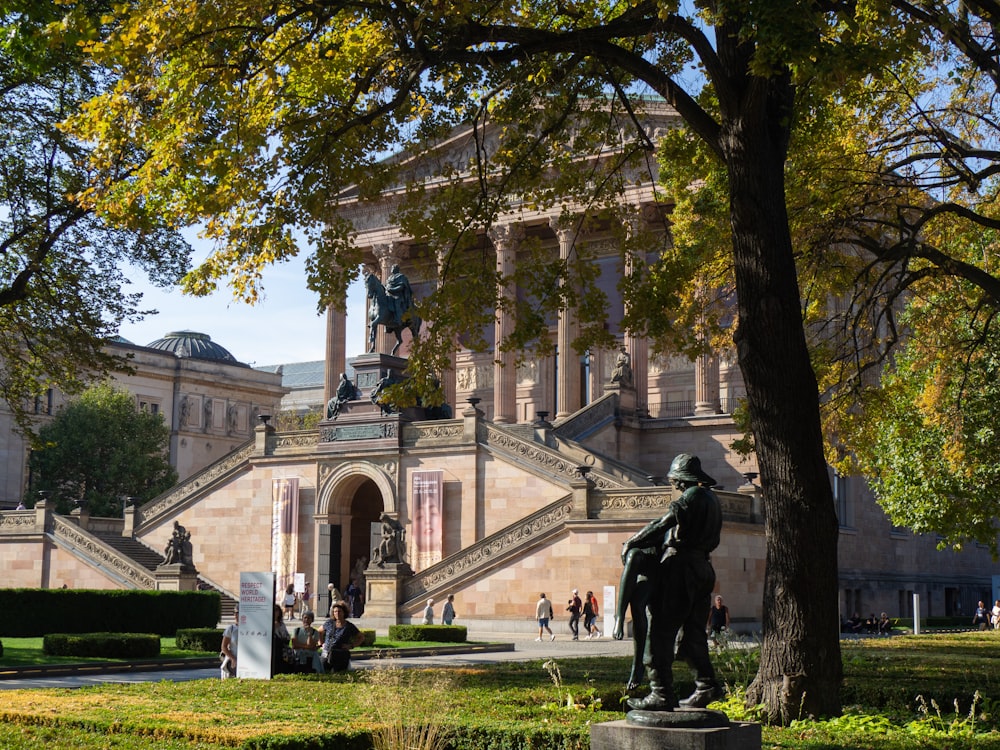 a statue of a man on a horse in front of a building