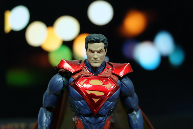 Close-up of a vibrant blue superhero bust printed in high detail on a 3D printer.
