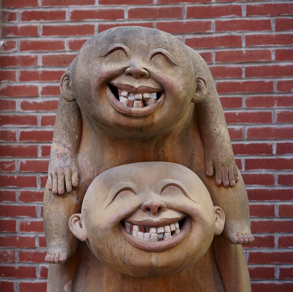 a statue of a laughing man holding a baby