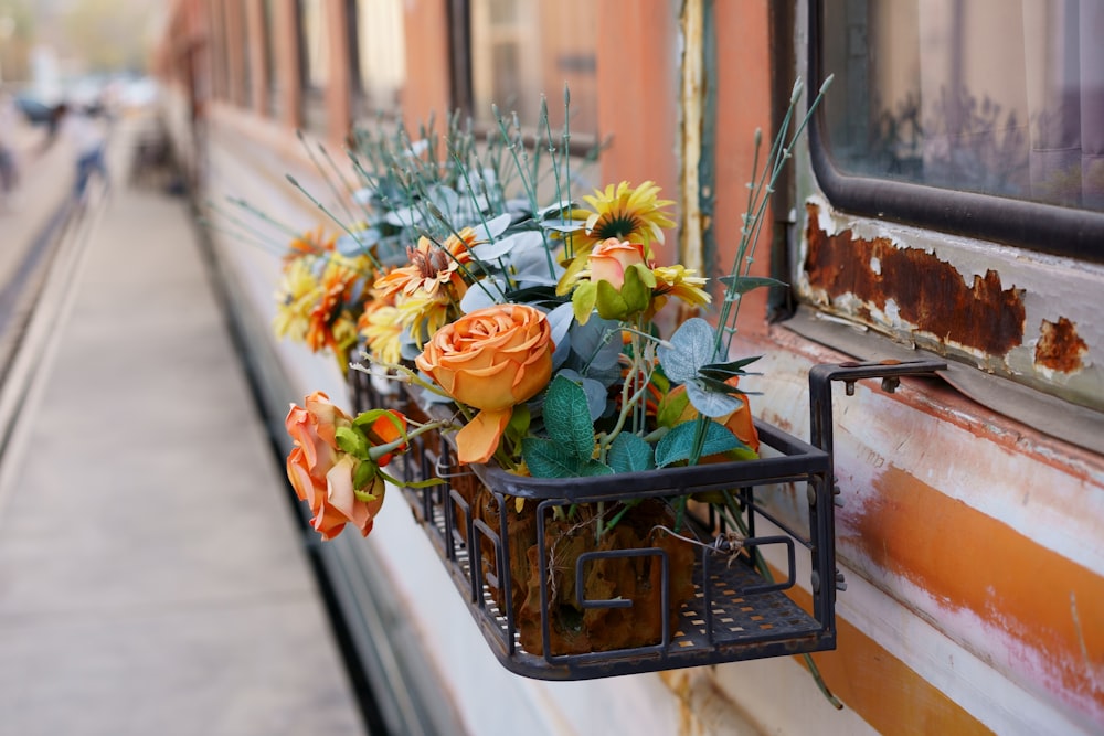 a window sill with a basket of flowers on it
