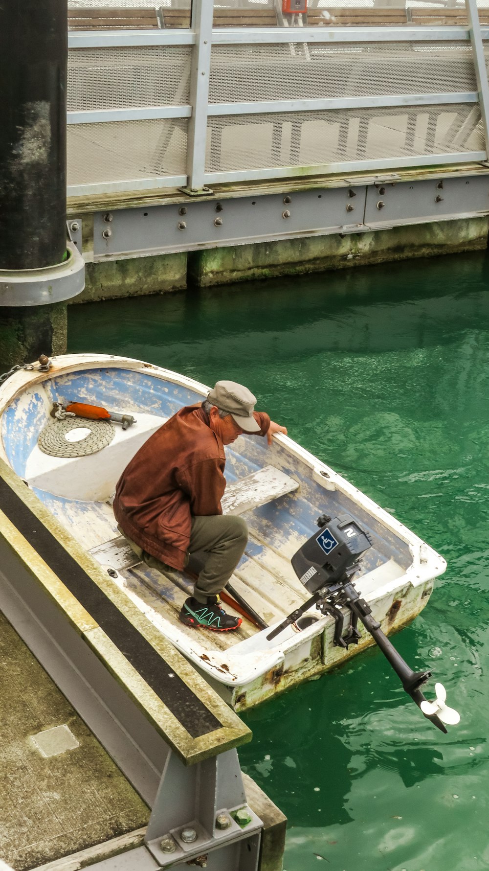 a man sitting in a small boat in the water