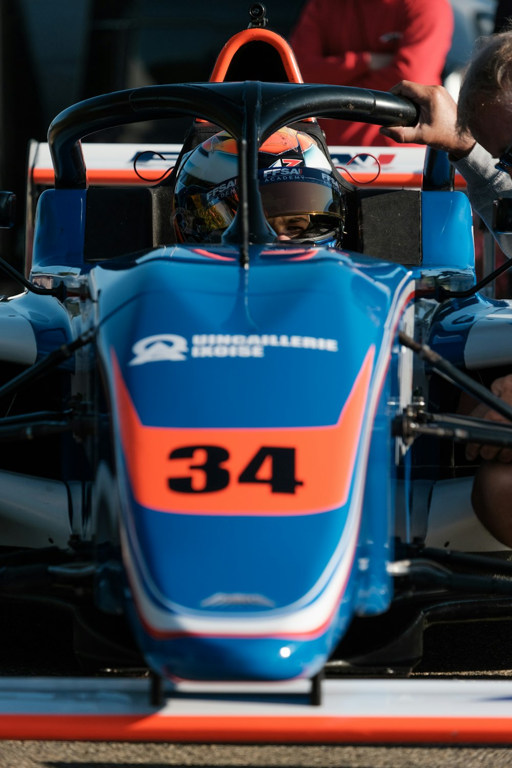a man sitting in a blue race car