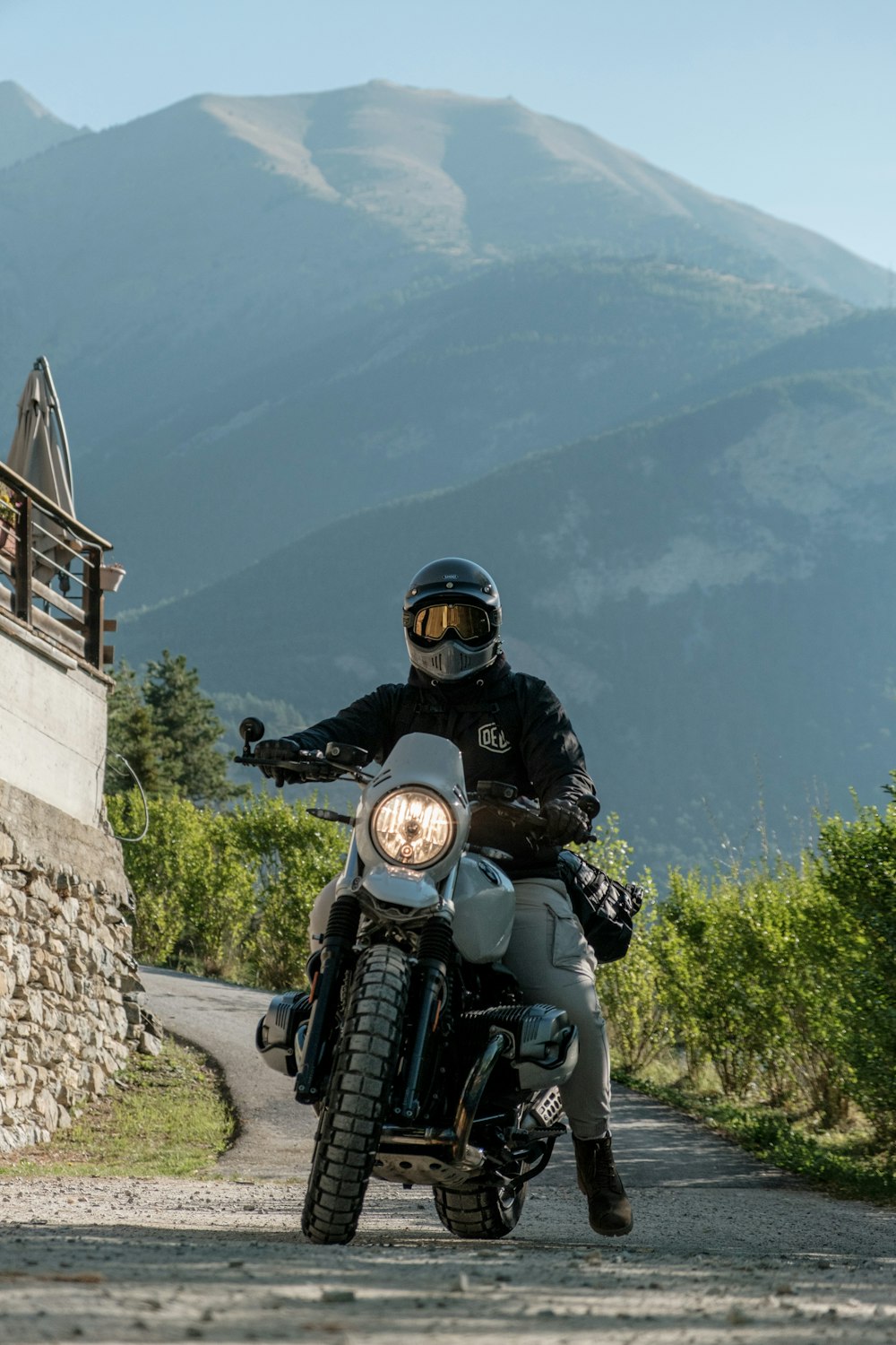 a man riding a motorcycle down a dirt road