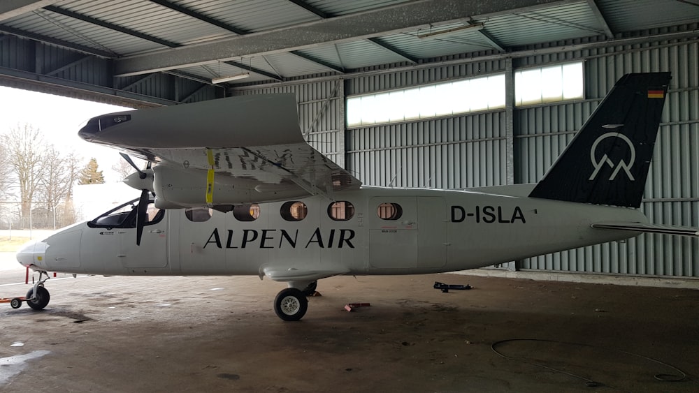 a small airplane parked inside of a hangar