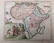 An old map showing the transatlantic slave routes with a faded photograph of an African family.