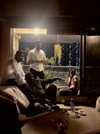 Friendly group of people chatting comfortably in a shared Dubai apartment near a metro station.