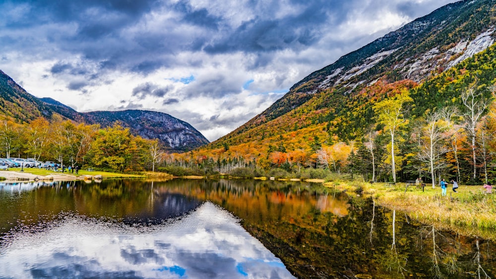 a lake surrounded by mountains in the fall