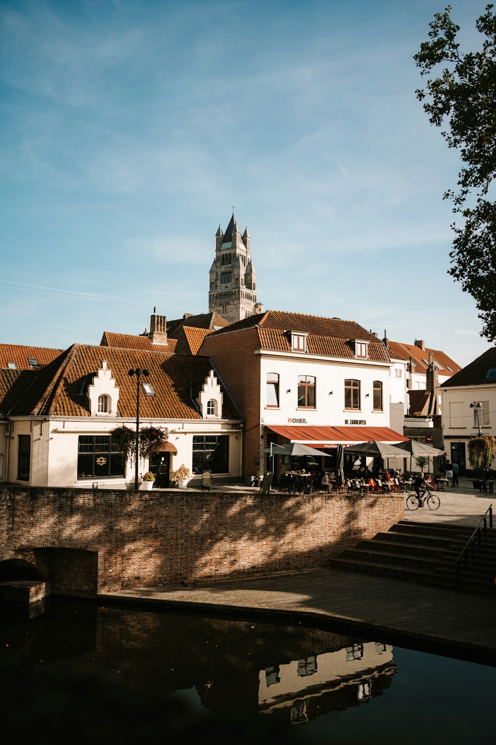 a building with a clock tower next to a body of water