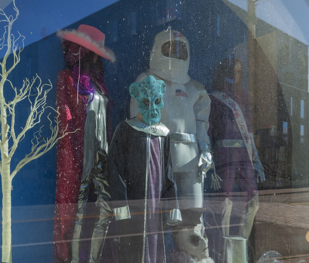 a group of mannequins in a window display
