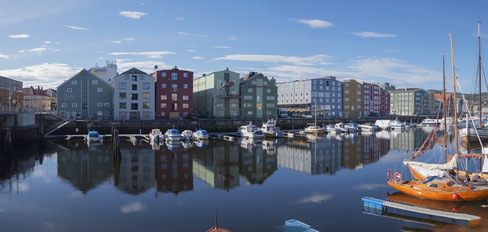 a harbor filled with lots of boats next to tall buildings