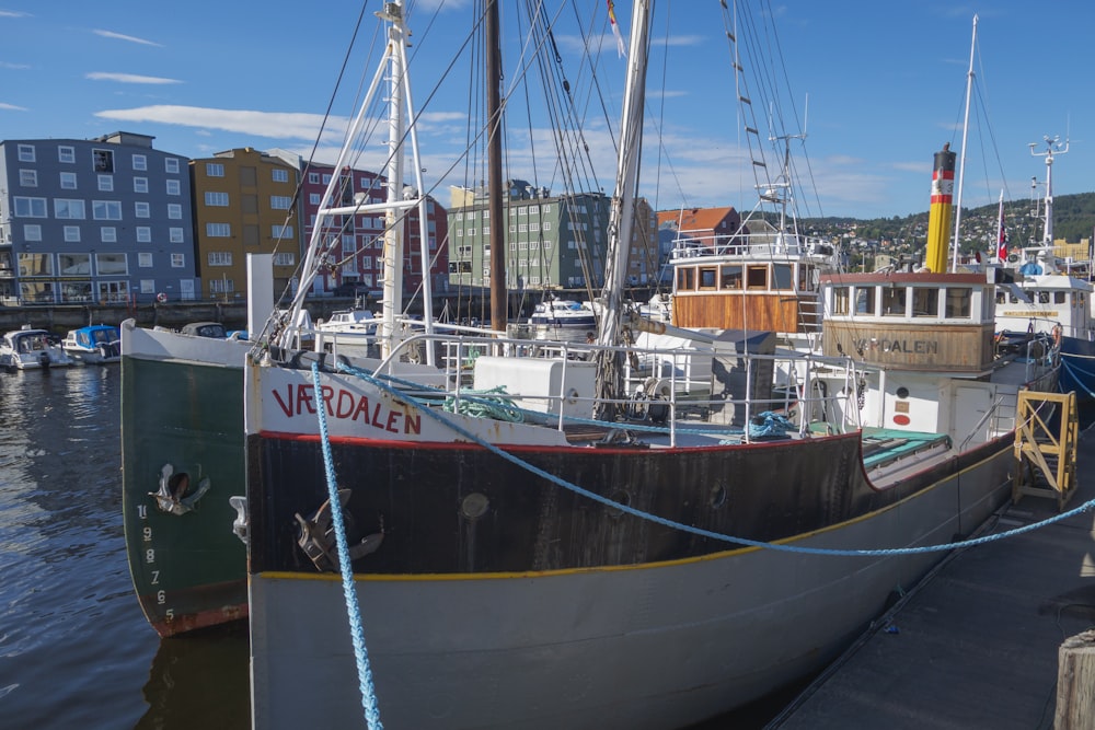 a boat tied up to a dock in a harbor