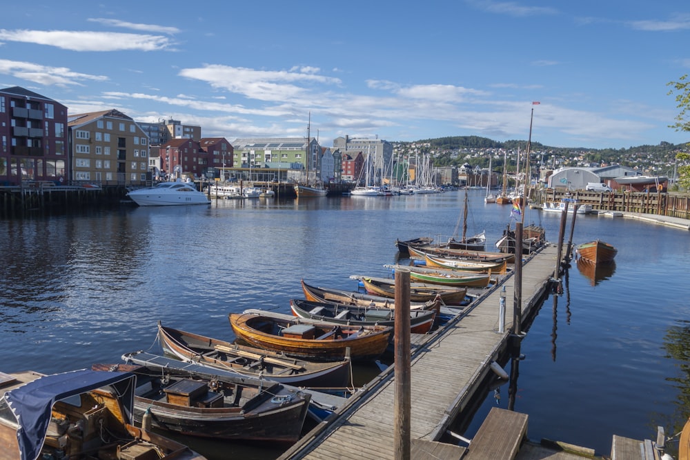 a row of boats sitting on top of a pier