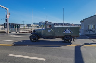 A delivery truck on the road with a clear blue sky background.