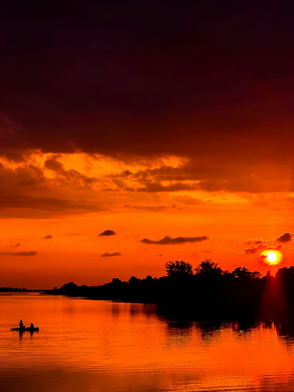 a couple of people in a boat on a body of water